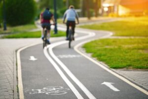 Curvy bike lane with markings and men cycling in the background,