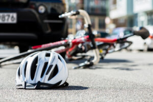 Bicycle and Helmet lying on the road after collision with a car