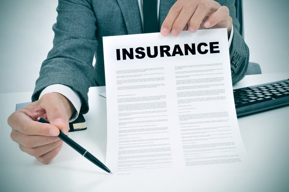 An Insurance Adjuster showing insurance policy to the claimant An Insurance Adjuster showing insurance policy to the claimant