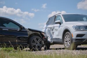 Cars crashed in T-bone shape in road accident.