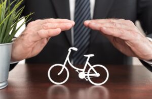 Insurer protecting a bicycle with his hands