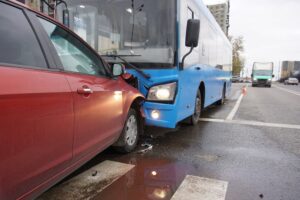 Head-on collision of a car and a bus at a pedestrian crossing