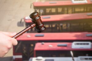 Judge's gavel and buses in the background.