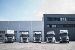 A row of new truck standing at the yard of trucking company
