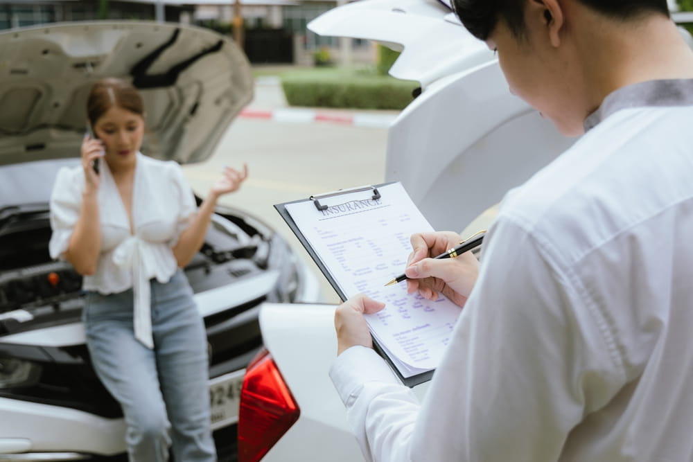 Insurance adjuster reviewing accident report and vehicle damage claim