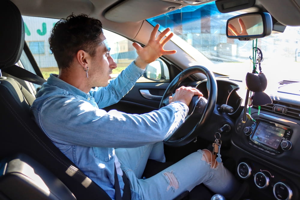 driver yelling in frustration during road rage incident