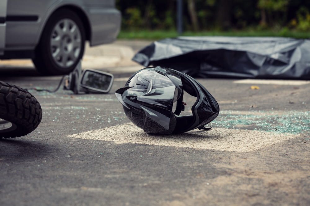 motorcycle helmet on road after crash caused by right of way violation