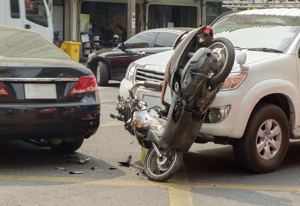 motorcycle accident caused by unsafe passing between vehicles